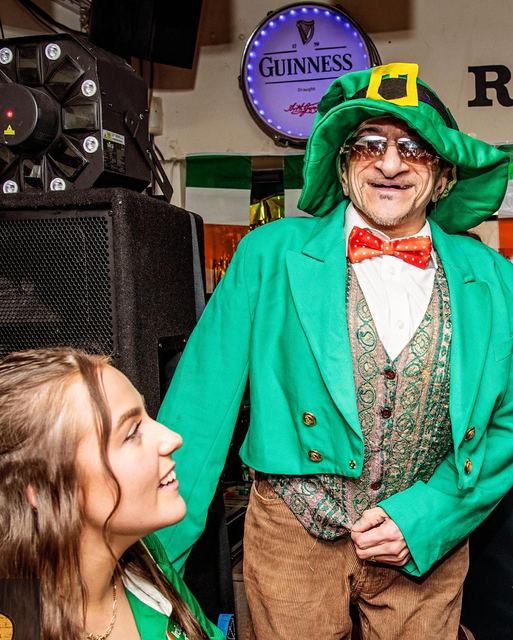A leprechaun chatting with a guest